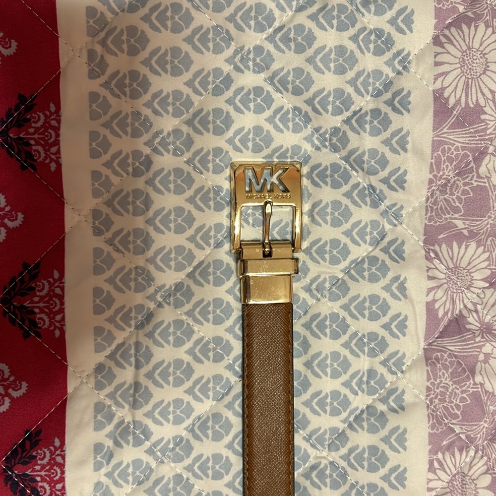 Michael Kors belt. It’s reversible with colors brown and gold.